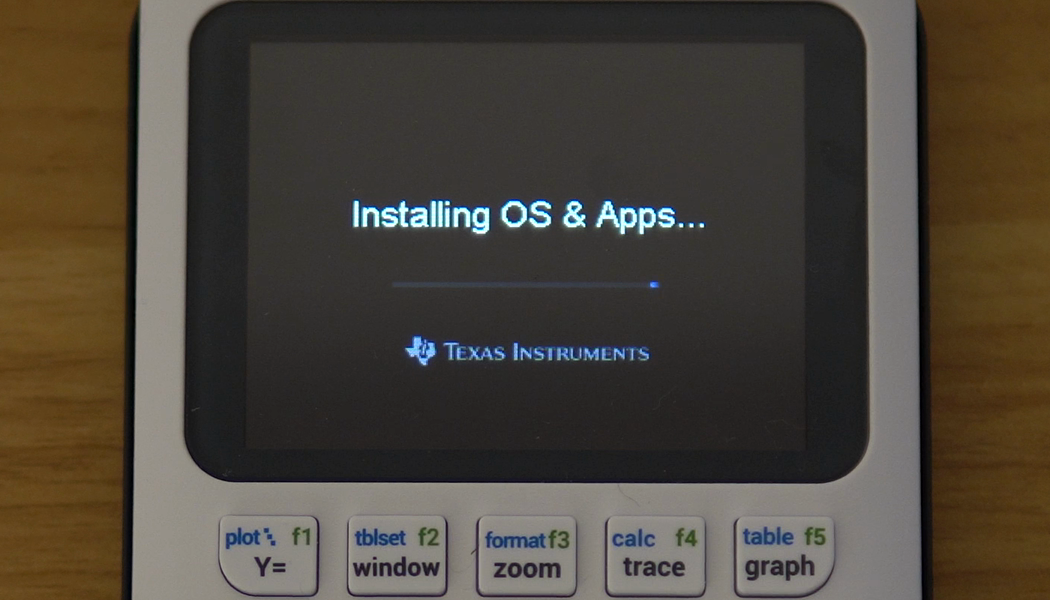 A TI-84 Evo connected by USB-C showing its Installing OS and Apps screen during the reinstall